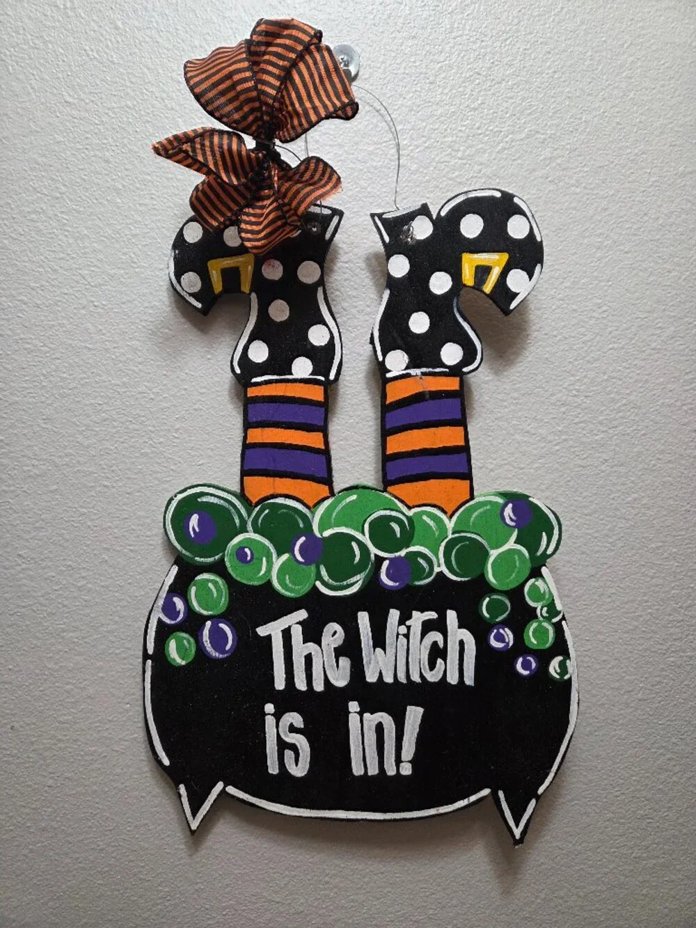 Handmade wooden Halloween door hanger shaped like a bubbling cauldron